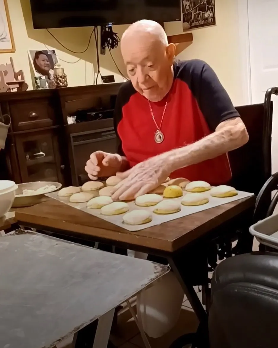 Candelario Torres, 94, shaping bread dough at his kitchen table